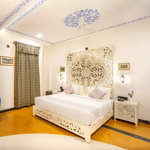 Suite room with carved jaali headboard