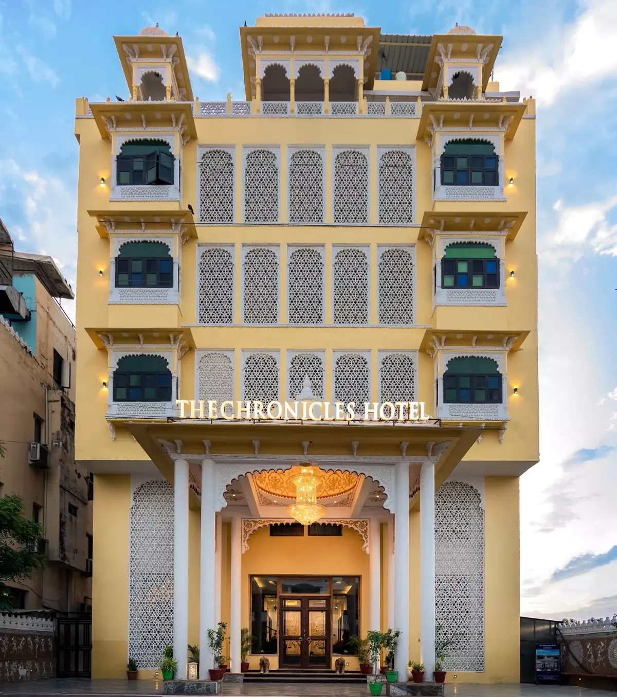 Sandstone facade with jharokha windows at The Chronicles Hotel, Udaipur